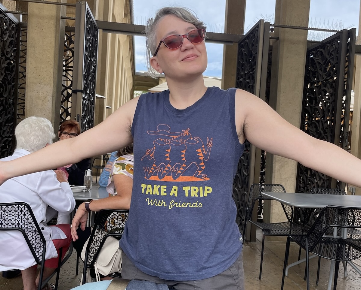 Me, on my birthday trip, wearing a tank top that reads 'Take a trip with friends'