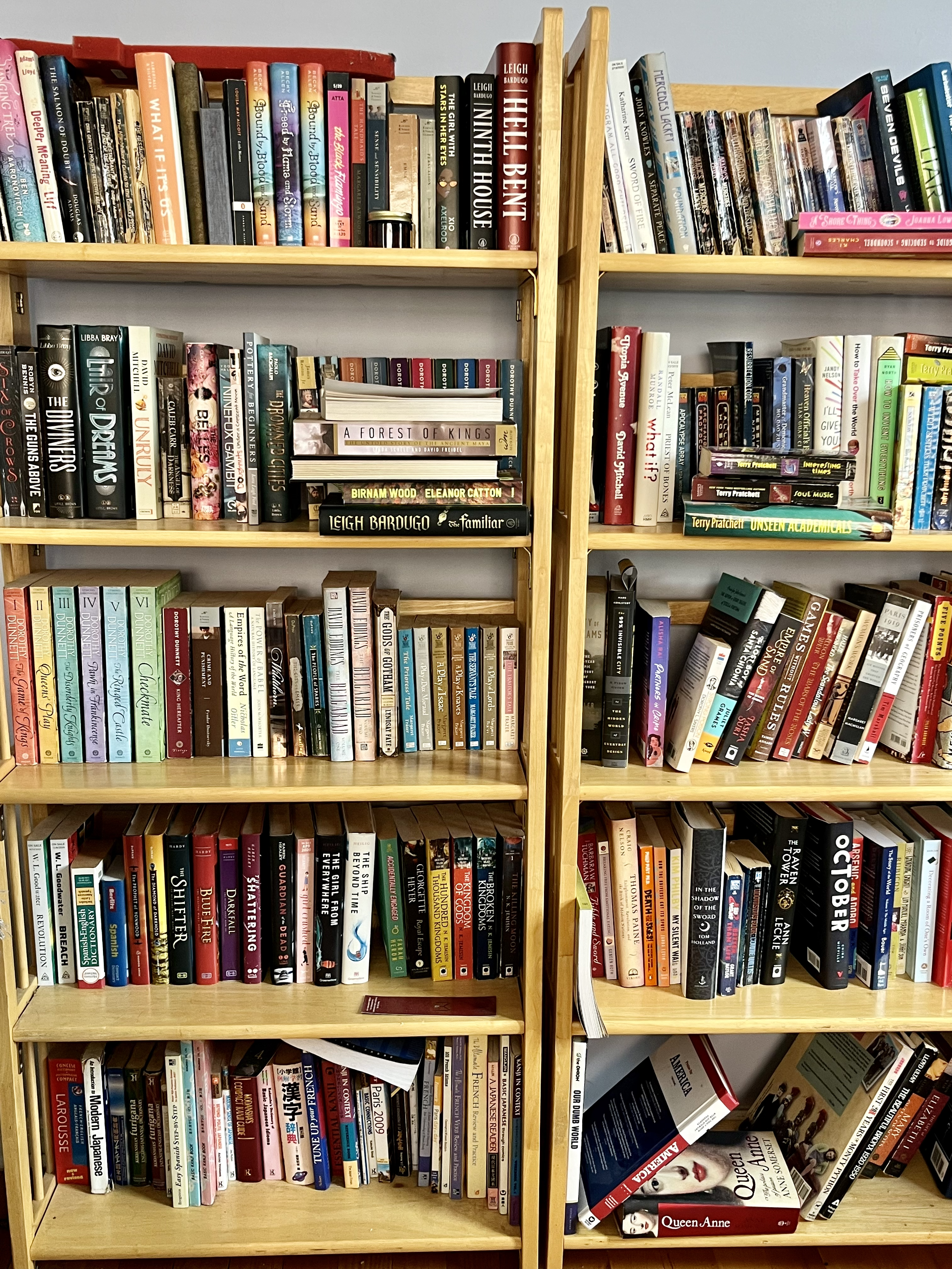 An image of large, messy bookshelves, stuffed full of all kinds of novels